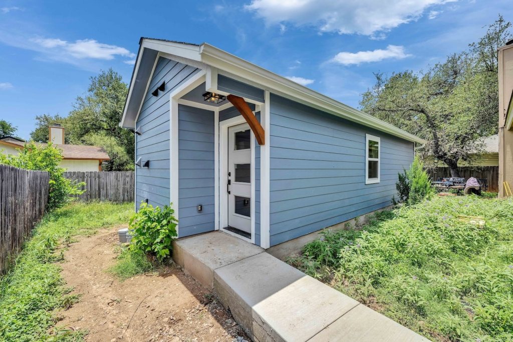 Blue tiny house with garden path